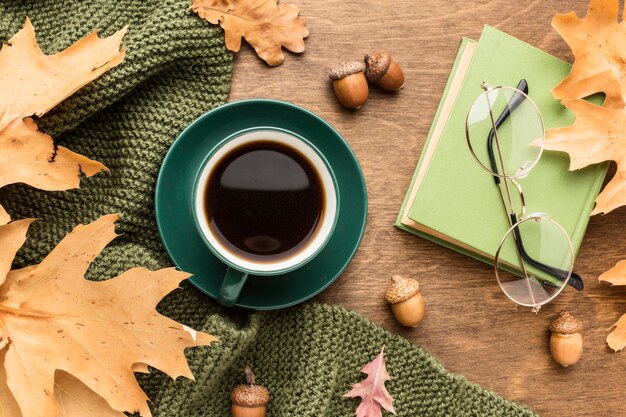 Top view of autumn leaves with coffee and glasses