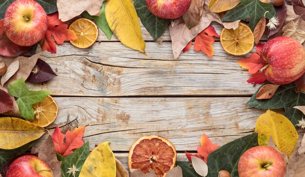 Top view of autumn leaves with copy space and dried citrus