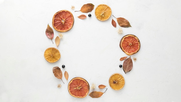 Top view of autumn leaves with dried citrus