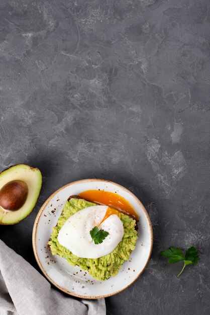 Top view of avocado toast with poached egg and copy space