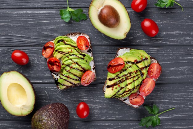 Top view of avocado toast with tomatoes and sauce
