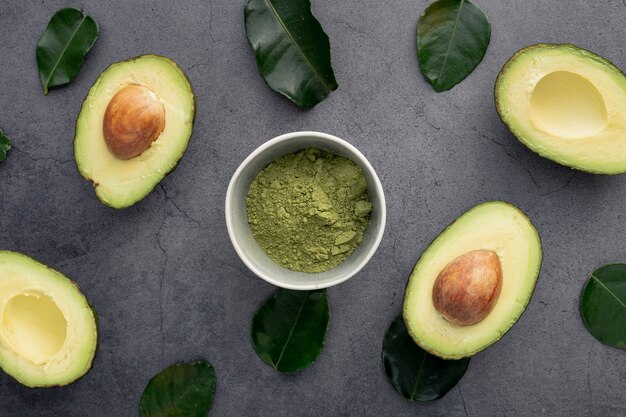 Top view of avocado with pit and leaves