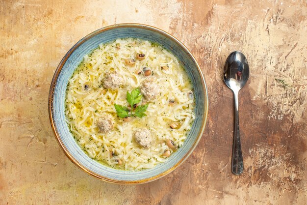 Top view azerbaijani erishte in bowl a spoon on beige background