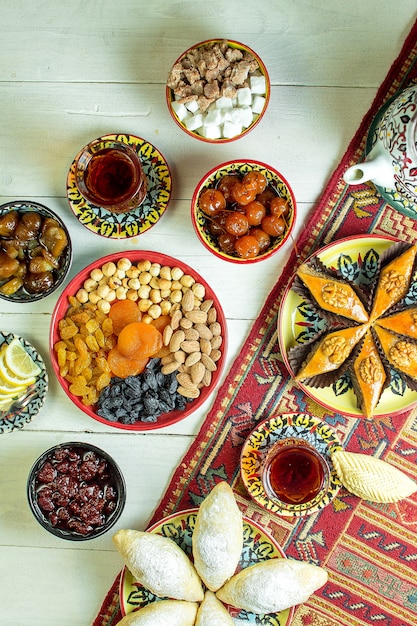 Free photo top view of azerbaijani pakhlava served with nuts dried fruits raisins and tea