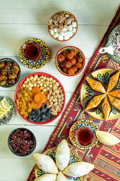 Top view of azerbaijani pakhlava served with nuts dried fruits raisins and tea