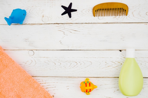 Top view baby bath accessories with wooden background