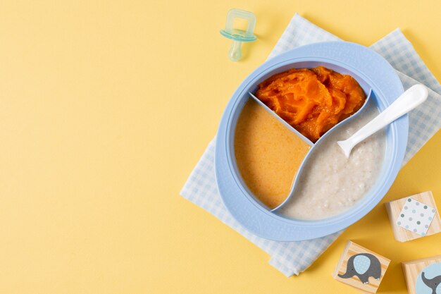 Top view baby food on yellow background