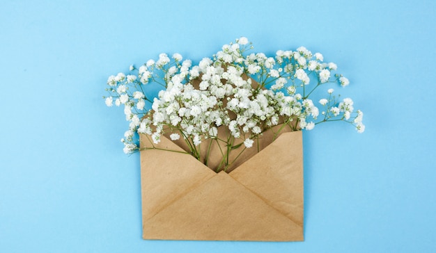 Top view of baby's breath flowers on brown envelope