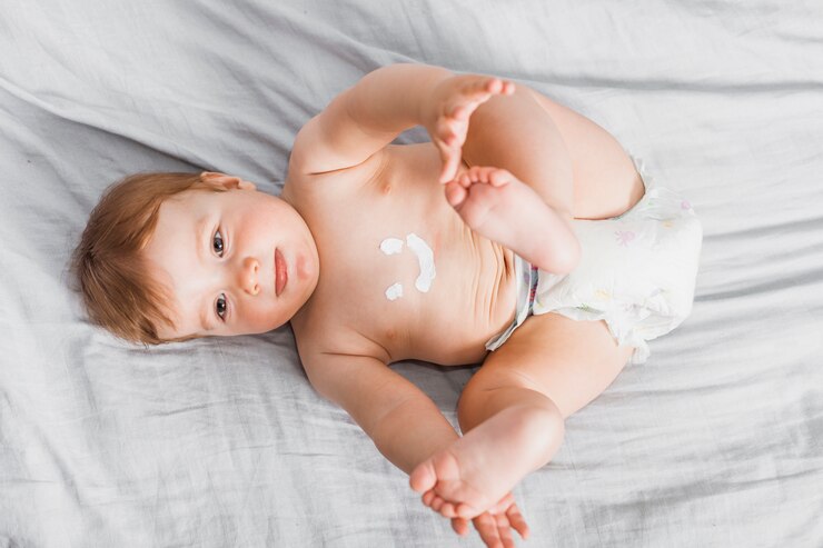 Free Photo top view baby spread with lotion
