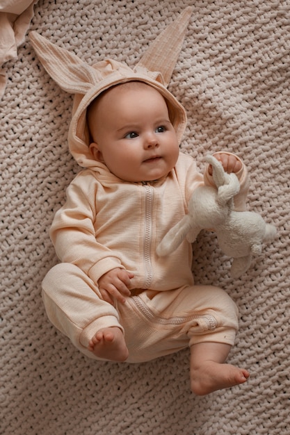 Free photo top view baby with stuffed toy