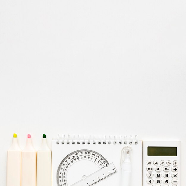 Top view of back to school essentials with calculator and notebook