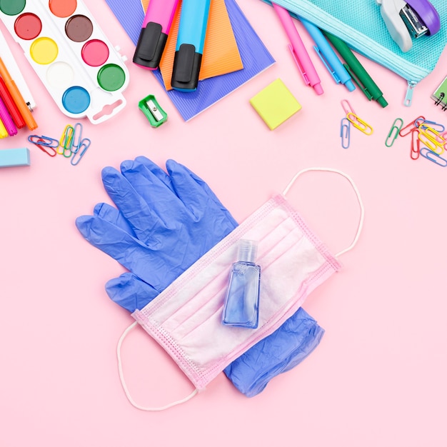 Top view of back to school essentials with medical mask and gloves