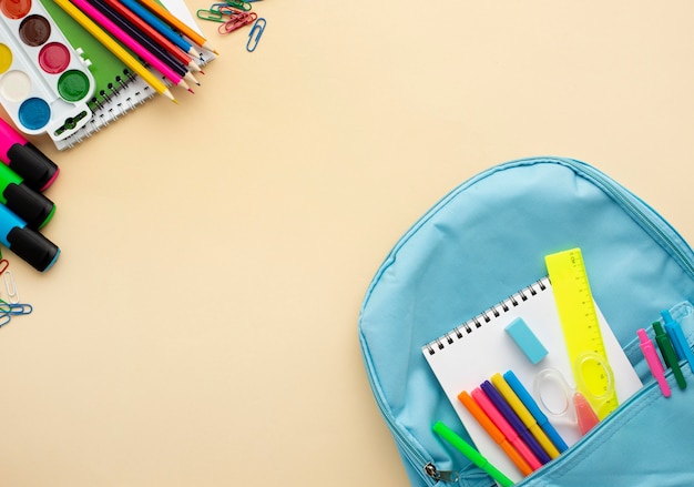 Top view of back to school stationery with backpack and colorful pencils