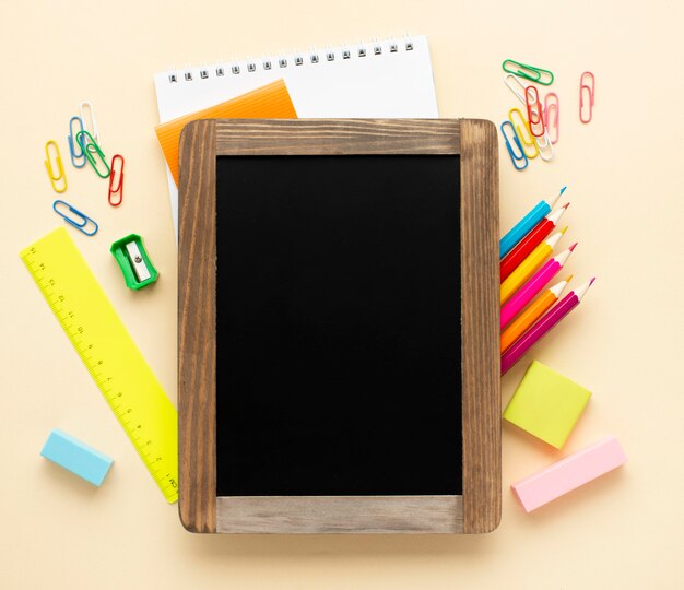 Top view of back to school stationery with blackboard and colored pencils