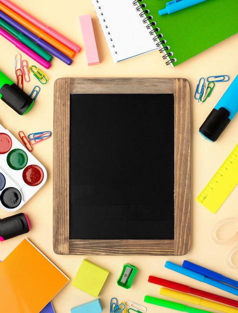 Top view of back to school stationery with blackboard