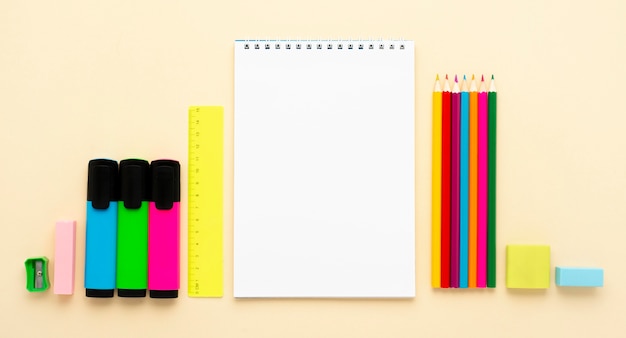 Top view of back to school stationery with pencils and notebooks