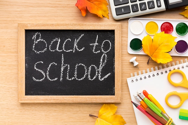 Free photo top view of back to school supplies with blackboard