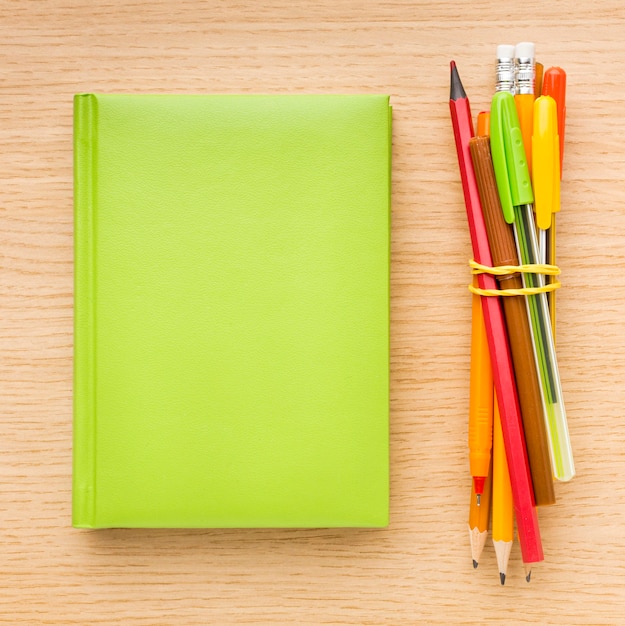 Top view of back to school supplies with book and pencils