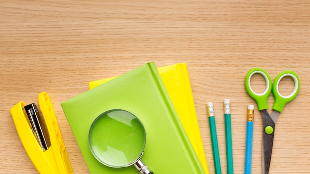 Top view of back to school supplies with books