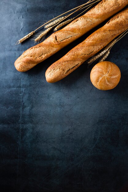 Top view of baguette on black background wirh copy space