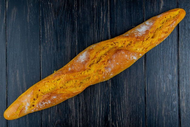 Free photo top view of baguette on wooden