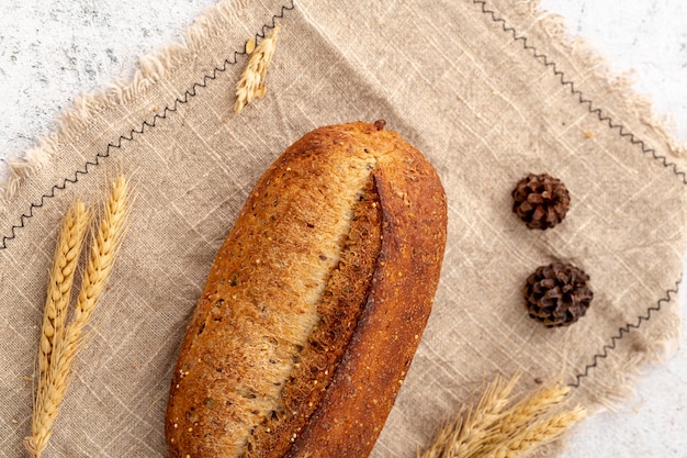 Top view baked bread on burlap fabric