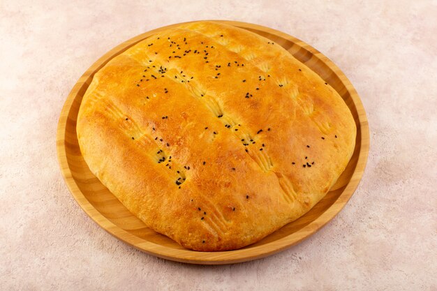 A top view baked bread hot tasty fresh inside round desk on pink