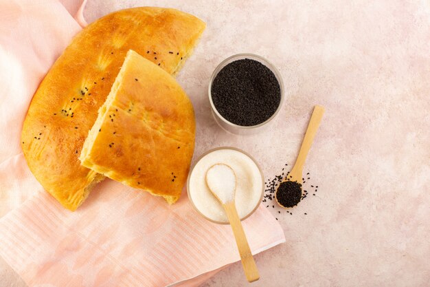 A top view baked bread hot tasty fresh sliced with salt and pepper on pink