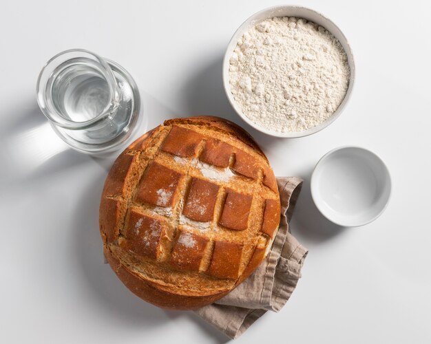 Top view of baked bread with flour and water