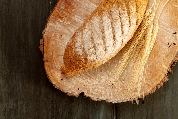 Top view baked bread on wooden board