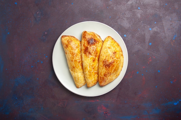 Top view baked pastries bread like inside plate on a dark space