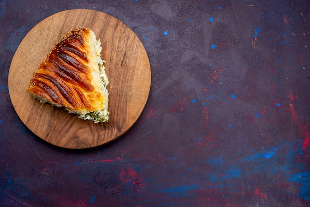 Top view baked pastry bun formed sliced with greens inside on dark-purple background.