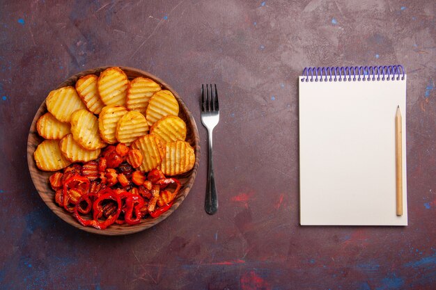 Top view baked potatoes with cooked vegetables inside plate on a dark space