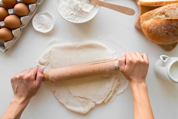 Top view baker rolling dough