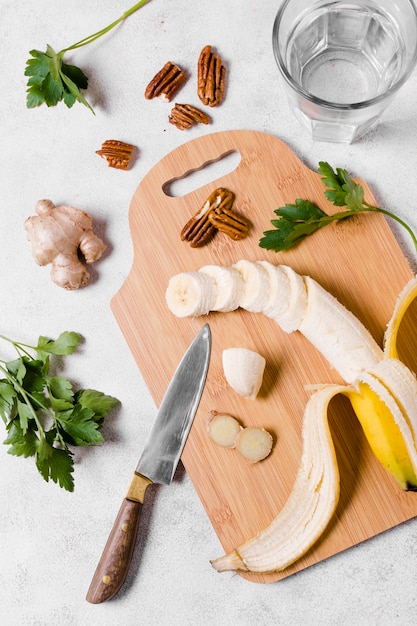 Top view of banana and ginger on chopping board