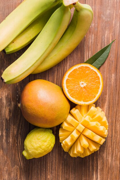 Top view bananas, orange and mango