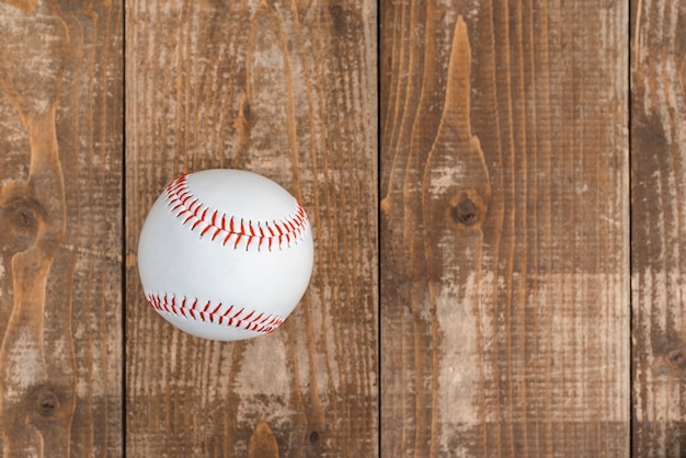 Top view of baseball on wooden background