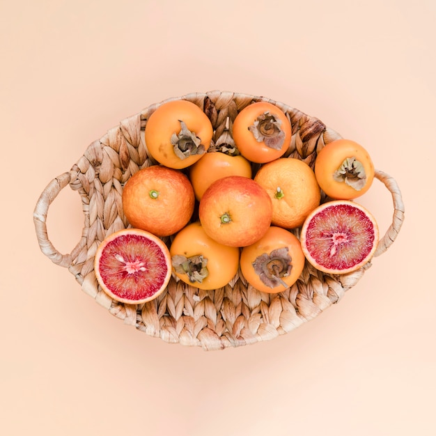 Top view basket filled with delicious persimmons