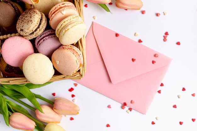 Top view of basket of macarons and envelope for valentines day