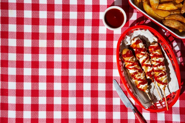 Top view basket with corn dogs and copy space