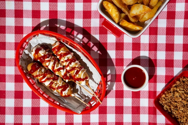 Top view basket with corn dogs on table