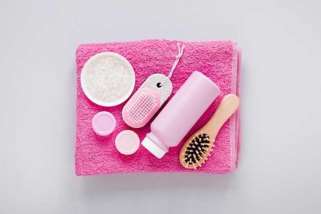 Top view of bath products on pink towel