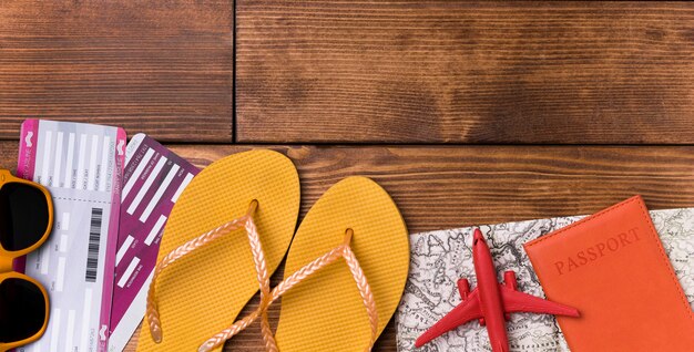 Top view beach slippers with passport on the table