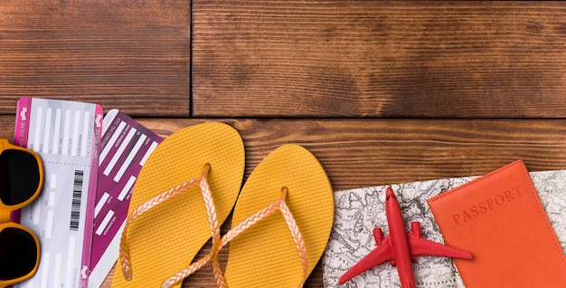 Top view beach slippers with passport on the table