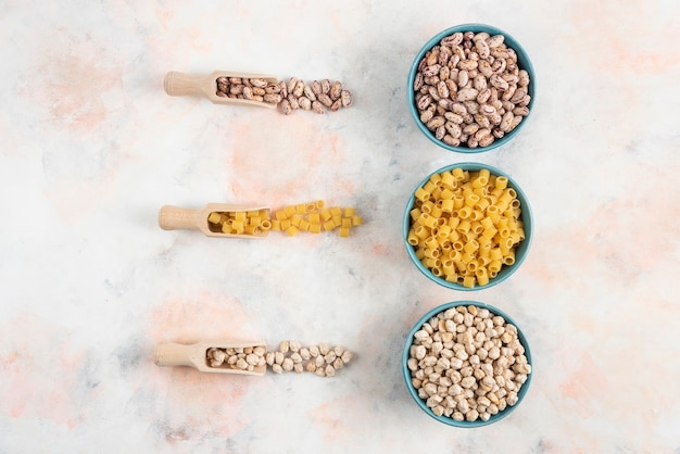 Top view Bean, pasta and chickpea in bowl on white surface. 