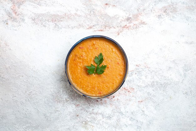 Top view bean soup called merci inside plate on a white surface soup meal food vegetable bean