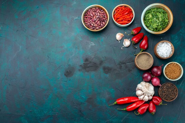 Top view of beans and peppers with onions garlics on dark, food meal ingredient product