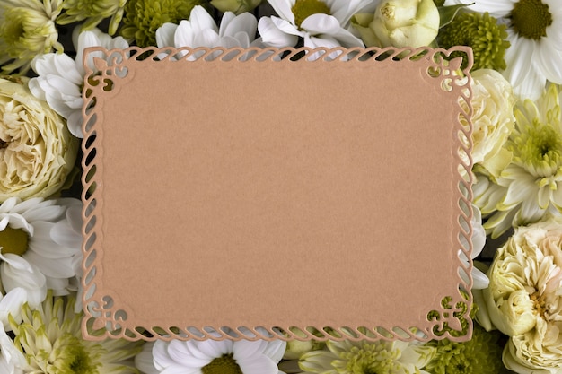 Free photo top view of beautiful flowers with blank card