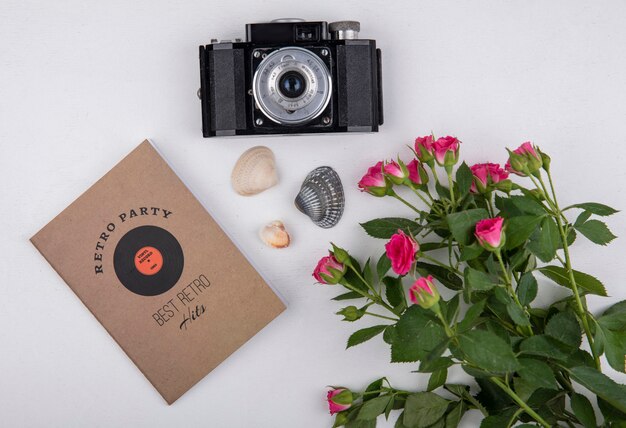 Top view of beautiful fresh pink roses with leaves with camera on a white background