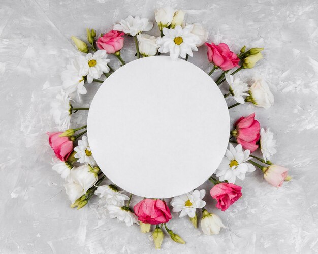 Top view beautiful spring flowers composition with round empty card